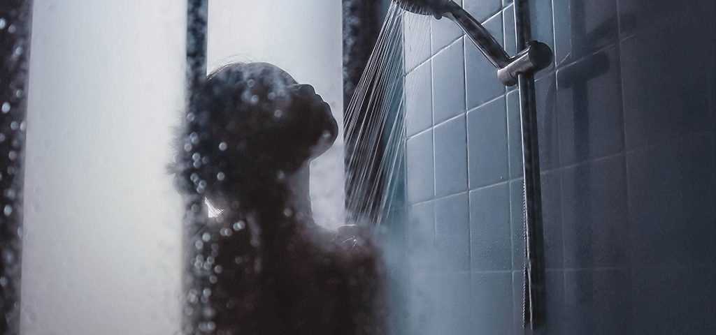 A Beginner’s Guide to Contrast Showers, image of a woman taking a contrast shower