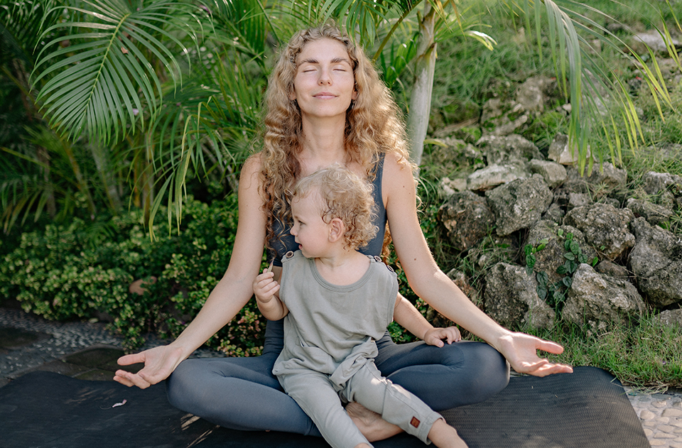 An Introduction To Mindfulness And The Effects On Your Habits, image of a mom and child sitting in a meditation pose